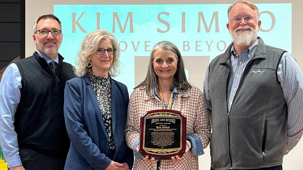 Dr. Jared Cleveland, Springdale Public Schools superintendent, Lenett Thrasher, AAESP Learning Services and Operations director, Kim Simco, Smith Elementary School principal, and Justin Swope, George Elementary School Principal and AAESP board member, pause for a group photo Feb. 23 following a surprise award assembly.