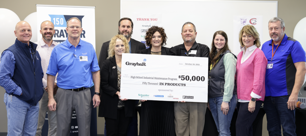 DTSOI staff receives a $50,000 check, part of which will go to DTSOI in total value of products